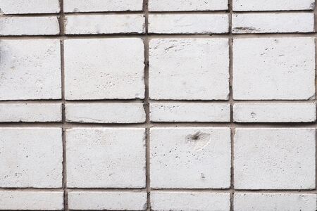 Background and texture light gray brick wall. Bricks of different sizes.の写真素材