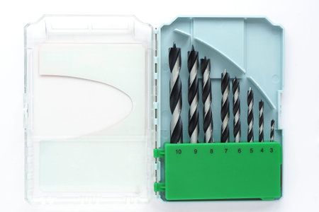 set of drills of different diameters in a plastic box. isolate on a white background.