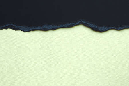 Abstract background and texture. Black torn cardboard and light yellow texture paper.の写真素材