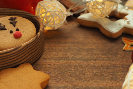 Cookies with a muzzle of a deer and in the shape of a star, a garland, cinnamon and star anise star...