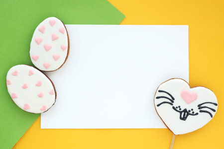 Gingerbread in the shape of a heart with a painted rabbit face and gingerbread cookies in the shape...