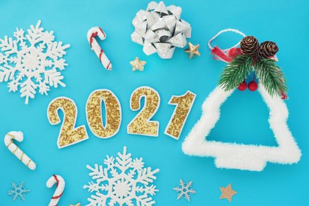 Number 2021 with golden shiny numbers with a white edge on a blue background. New Year, Christmas...
