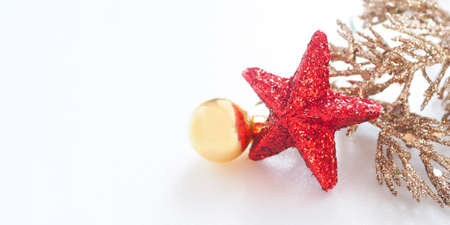banner red shiny star, golden Christmas ball and golden fir branch on white background. copy space.の写真素材