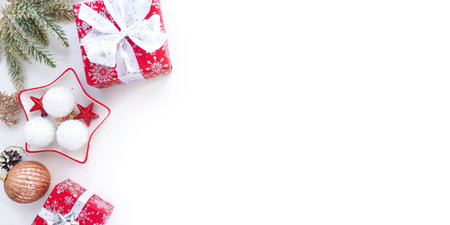 banner of Christmas branches, gift boxes and Christmas toys on a white background. copy space.