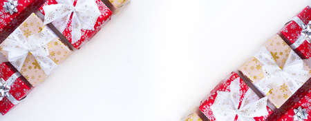 Christmas gift boxes with beautiful bows and ribbons on a white background. Copy spaceの写真素材