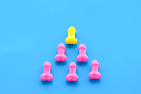 a pyramid of candy. yellow at the top and pink at the bottom. the concept of superiority, goal achievement, male superiority, patriarchy.の写真素材