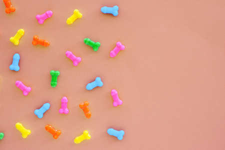 multi-colored sweets in the form of penises on a light background. copy space.の写真素材