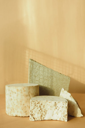 different concrete textured debris on a beige background. podium for advertising and promotion of...