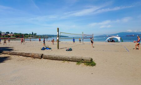 Kitsilano Beach~Vancouver BC, Canada. June 2 2019 People enjoying the weather playing volleyball at Kitsilano Beach in Vancouver British Columbia, Canadaのeditorial素材