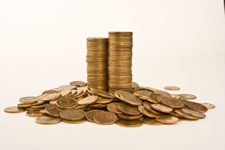 A pile of yellow coins against white background.の写真素材