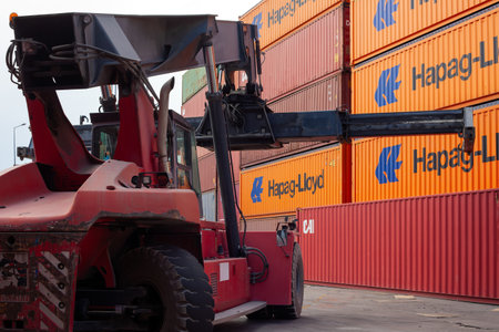 Istanbul, Beylikduzu - Turkey - 07.07.2023 Container yard for Logistic Import Export business, colorful container stack. crane hold a container and truck wait for load.のeditorial素材