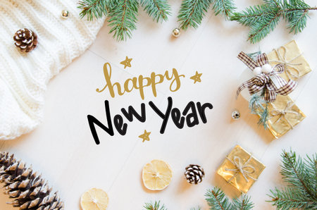 Christmas and New Year gifts, fir branches and pine cones flat lay background with hand lettering....