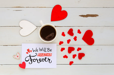 St Valentine's Day vintage overhead composition of note with love confession, hearts and coffee mug...