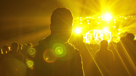 university youth festival crowded concert environment. Lonely man.の写真素材