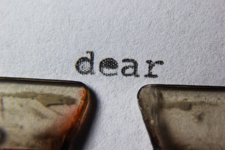 retro old typewriter.The word dear is written on paper.Mechanical tools for writing Old time journalismの写真素材