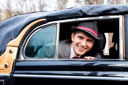 smile happy groom in retro carの写真素材