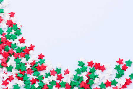 Frame made of small colored stars on the white backgroundの写真素材