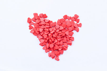 Heart shape consists of small read hearts on the white backgroundの写真素材