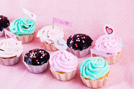 choloate cupcakes with hearts on pink backgroundの写真素材