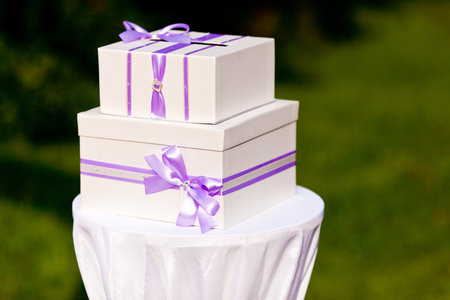 Present white box with violet silk ribbonの写真素材