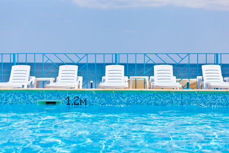 white lounge chairs on sea backgroundの写真素材