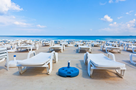 white lounge chairs on sea backgroundの写真素材