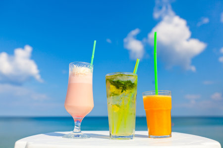 colorful cocktails on sea backgroundの写真素材