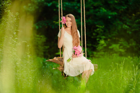 beautiful girl with bouquet of flowers in outdoorの写真素材