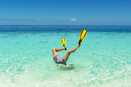 diver jump to the whater with flippers on his legsの写真素材