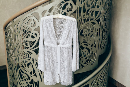 Wedding beautiful peignoir on hanger hang on the railing. Closeupの写真素材