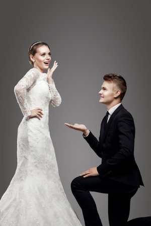 Groom in yellow bow-tie with bride, studioの写真素材