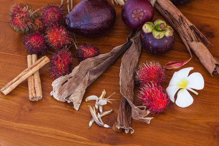 Fresh juicy tropical fruits on wooden table background, top view close-upの写真素材