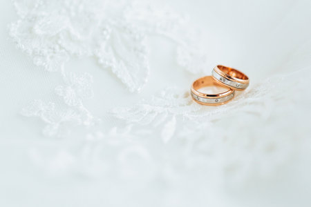 Golden wedding rings on veil. Close-upの写真素材
