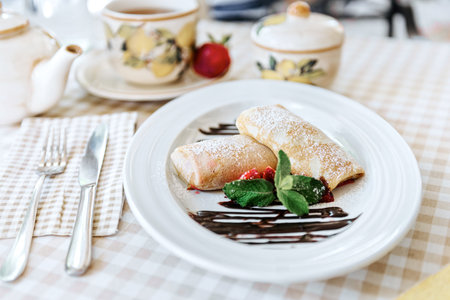 Pancakes with chocolate, fresh strawberry and mintの写真素材