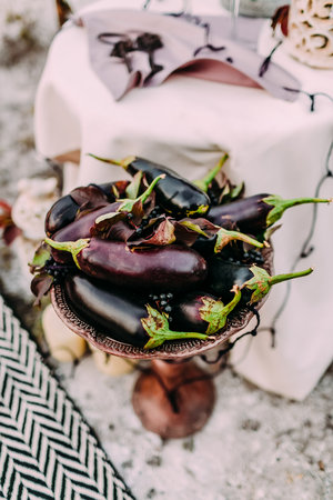 Eggplants lie on an iron decorated standの写真素材