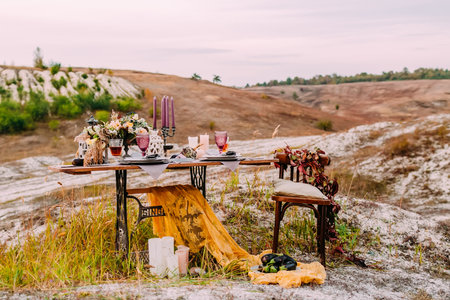 Wedding decorated table for two are standing on the open air in wedding ceremony areaの写真素材