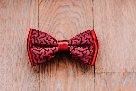 Stylish red bow on wooden background, groom getting ready in morning before the wedding.の写真素材