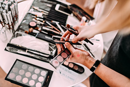 Hands of a makeup artist. Workplace makeup artist. Set of brushes for makeup.の写真素材
