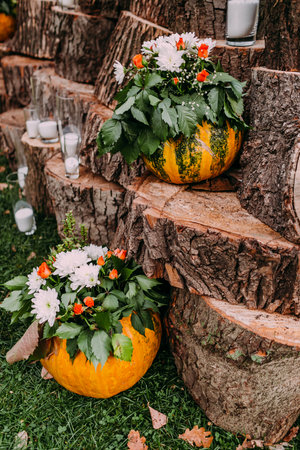 Beautiful wedding decoration autumn wedding in orange colors. Pumpkins, flowers, and candlesの写真素材