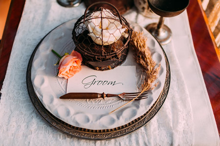 Table served in rustic style for wedding dinner. The place of the groom at the festive table. Close-up, top viewの写真素材