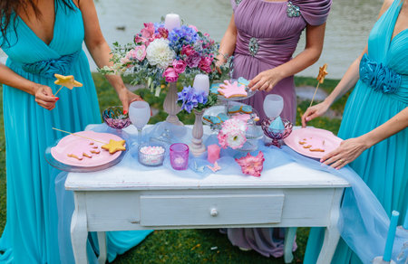Wedding decoration in the style of boho, floral arrangement, decorated table in the garden. Bridesmaids near the festive table at the ceremony. Close-upの写真素材