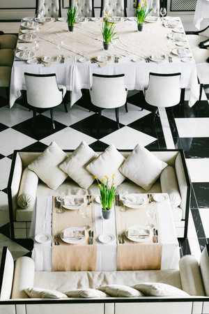 Stylish black and white dining tables and chairs. Minimalist interior in monochrome. Empty restaurant top view. Wedding preparetionの写真素材