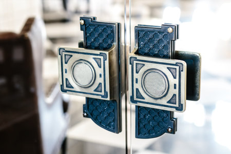 Steel, vintage ornate handles on the glass doors. Close-up image