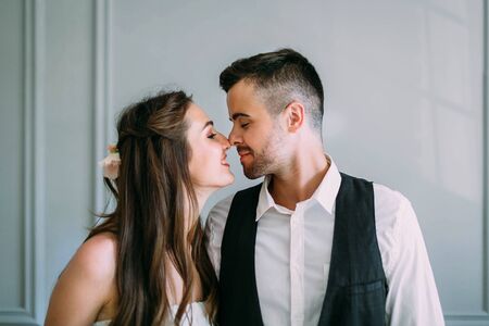 Young and happy newlyweds are touching noses . Close-up portraitの写真素材