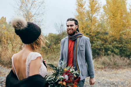 First meeting of bride and groom. The groom goes to the bride. Autumn wedding ceremony outdoors. Artworkの写真素材