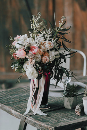 Flower composition with white and pink roses and other flowers on a rustic table. Artwork. Indoors.の写真素材