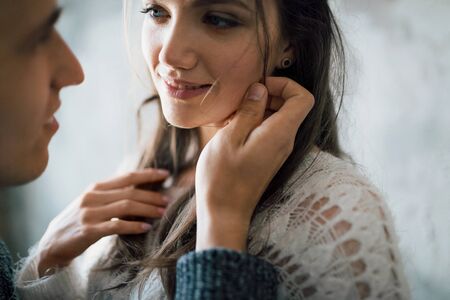 Tender moment before a kiss. Selective focus on the girl. Close-up portrait. Indoorsの写真素材