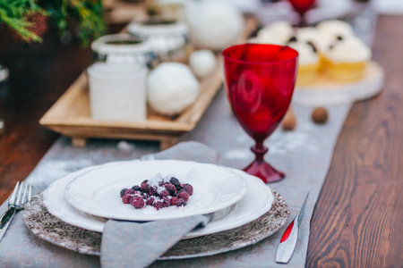 White Plate and Cutlery on Rustic Old Wooden Table. Wedding decoration. Artwork.