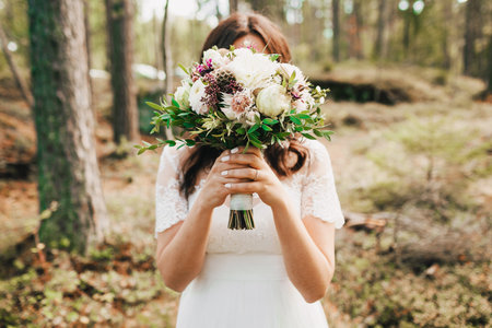 Bride Covering Her Face With Bouquet. Artwork. Close-upの写真素材