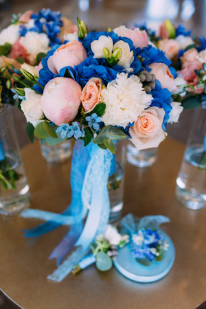Bridal bouquets with creamy roses and peonies and blue hydrangeas. Wedding morning. Close-upの写真素材